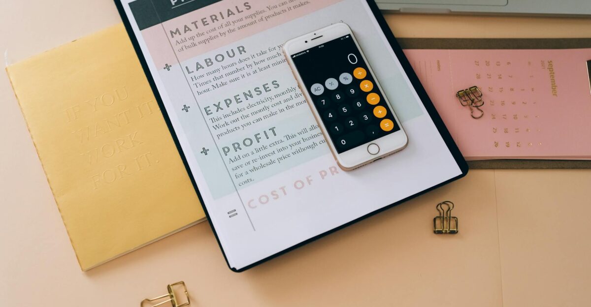 Organized business tools with a smartphone documents and stationery in a flat lay format