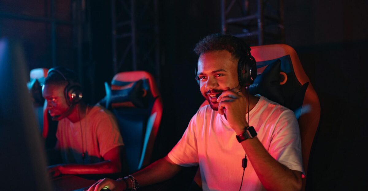 Two gamers immersed in an esports tournament focused with headsets and keyboards
