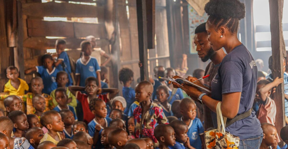 Volunteers conduct an educational session for children in an indoor community space