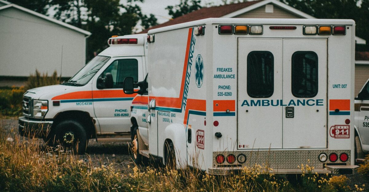 Two ambulances parked in a rural setting ready for emergencies