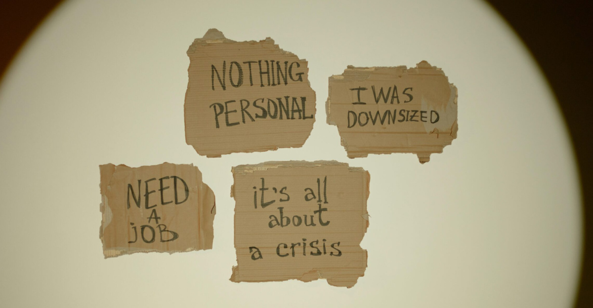 Cardboard signs convey job loss and economic crisis message, ideal for articles on unemployment.