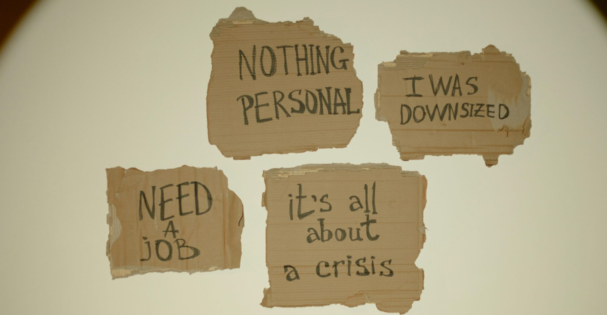 Cardboard signs convey job loss and economic crisis message, ideal for articles on unemployment.