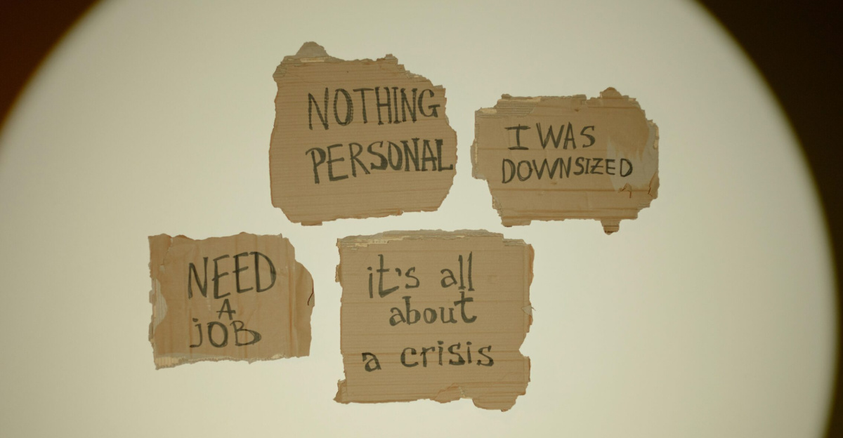 Cardboard signs convey job loss and economic crisis message, ideal for articles on unemployment.