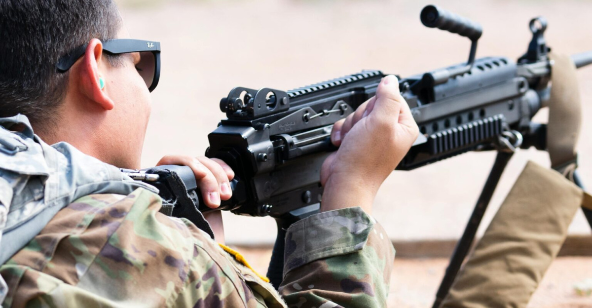US Army soldier practicing aiming with an M249 in a training exercise outdoors.