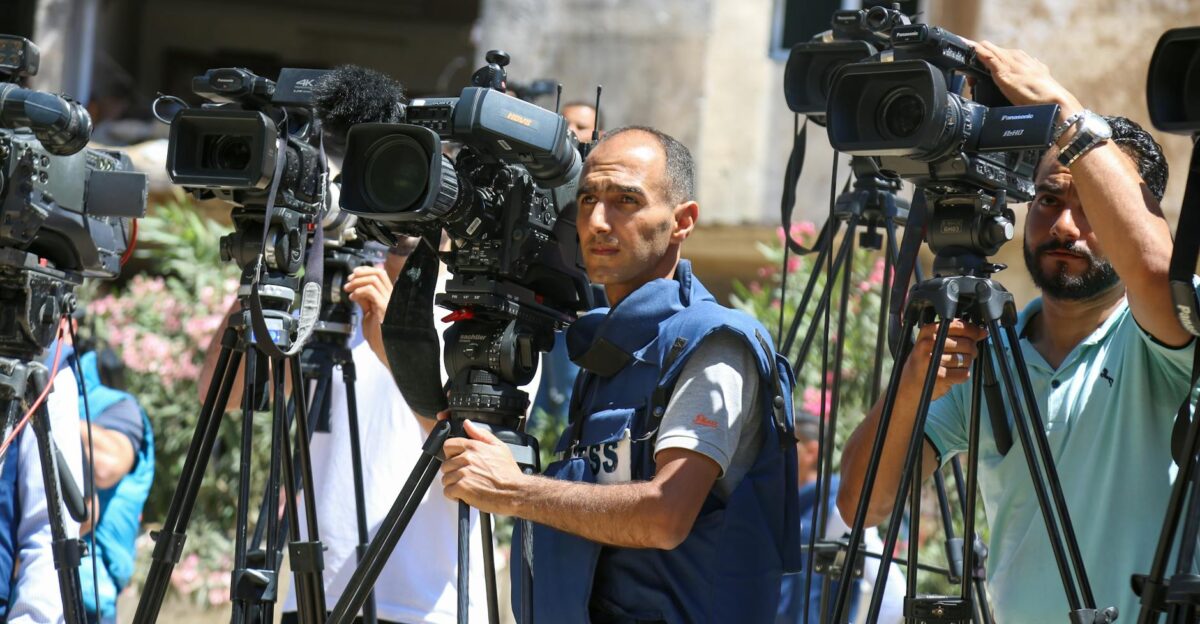 Journalists filming a live broadcast outdoors in Gaza Strip