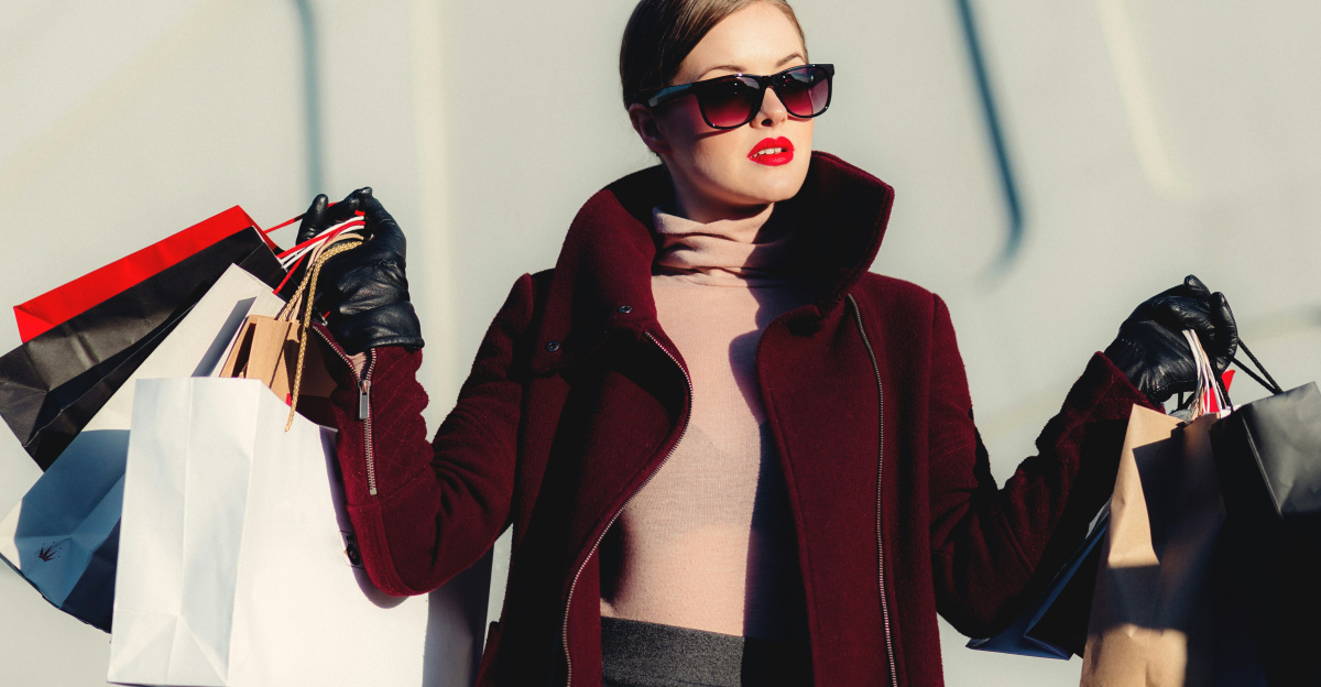 photo of woman holding white and black paper bags