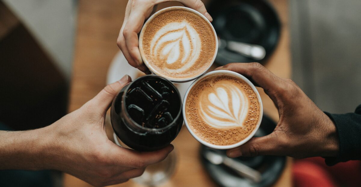 three person holding beverage cups