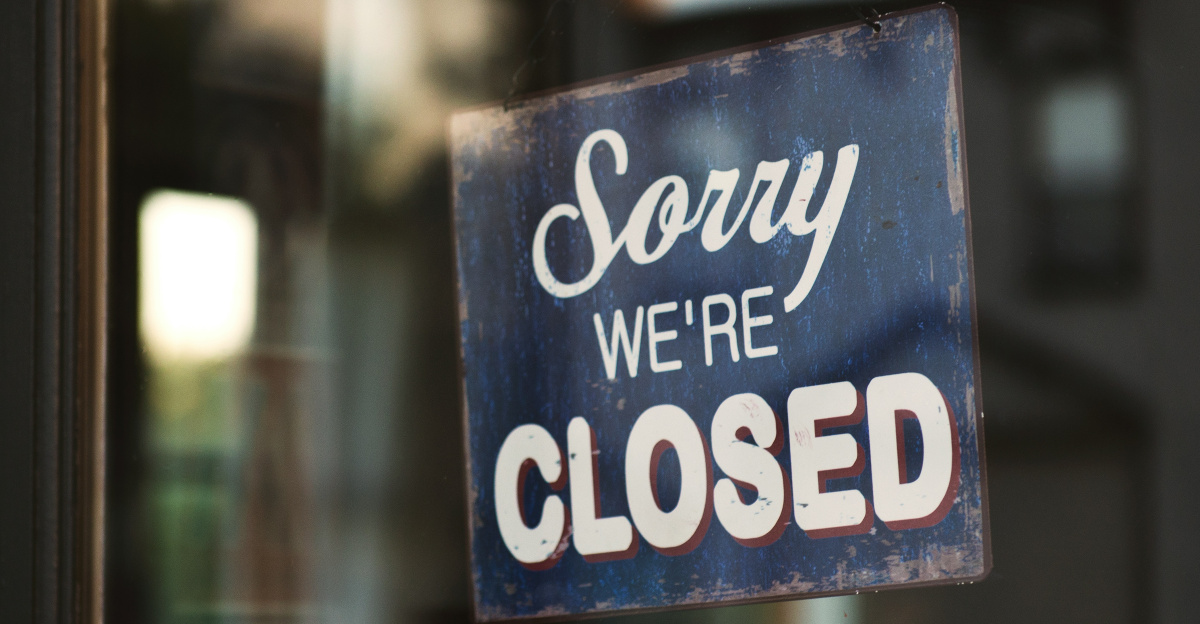 Sorry we're closed signage hanged on glass door