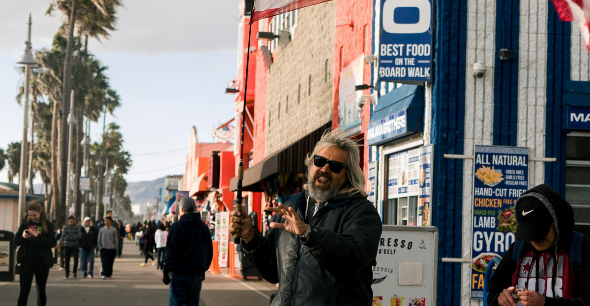 man standing near building and flag of America