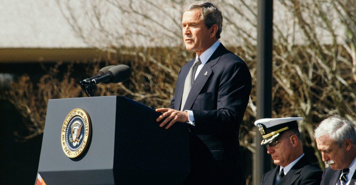 George W Bush standing on lectern during daytime