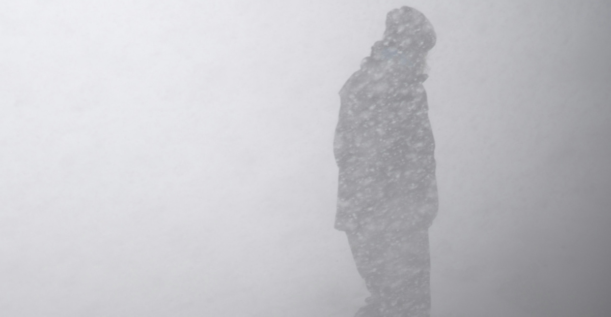 silhouette of man in snow storm