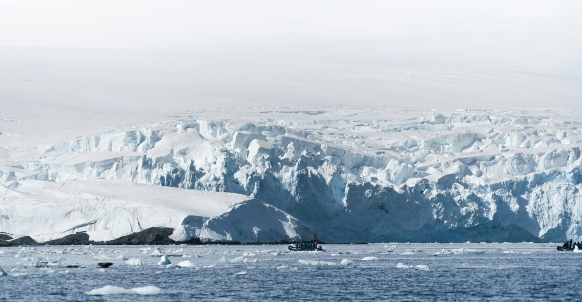 snow-covered mountain near body of water