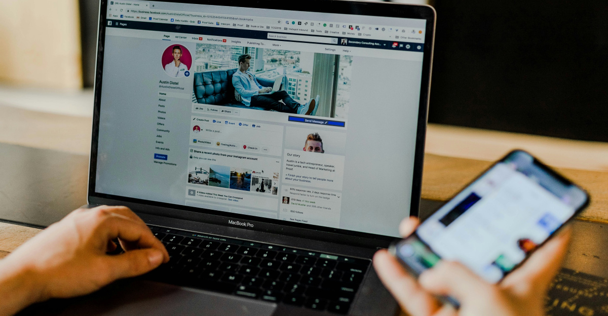 person using both laptop and smartphone