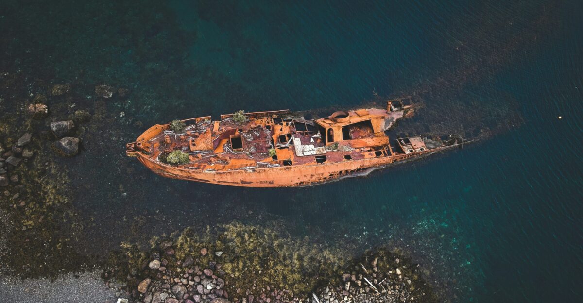 an old rusted boat in a body of water