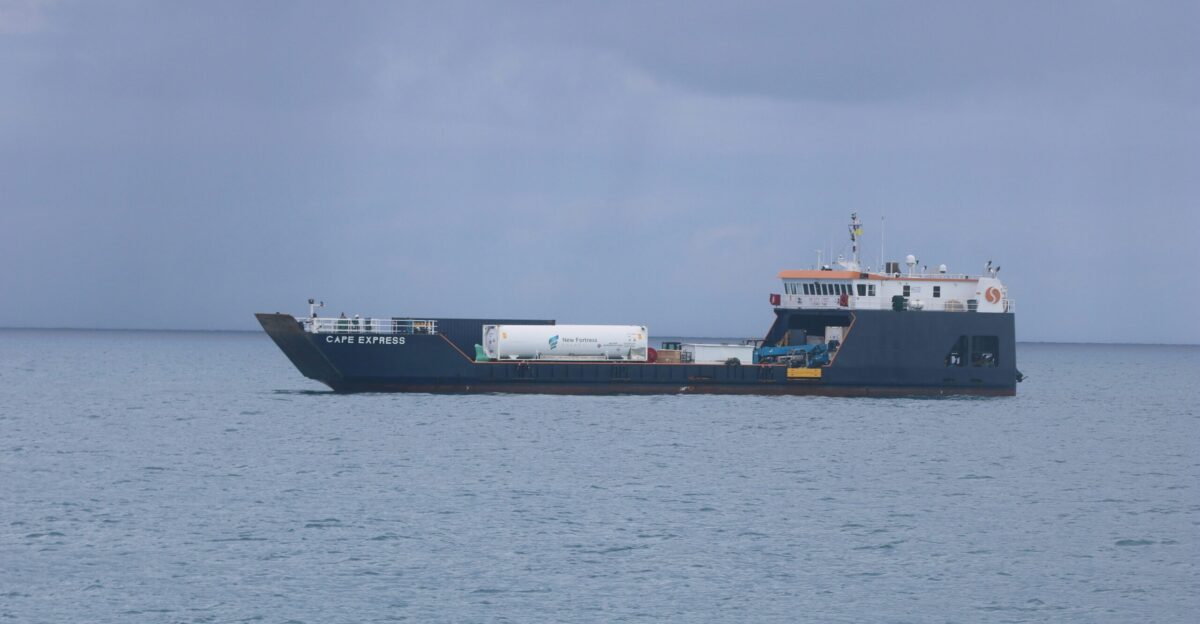 whtie and gray cargo ship in the midle of ocean