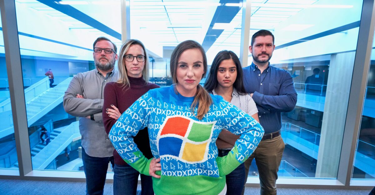 woman wearing blue Windows sweater standing