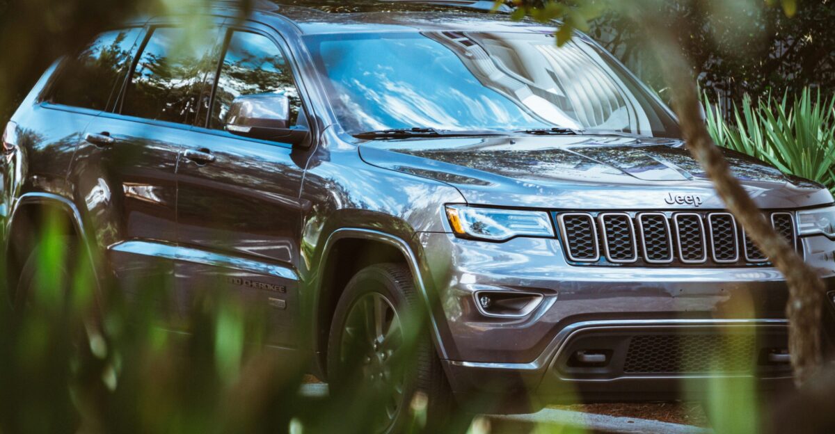 gray Jeep Cherokee beside plants