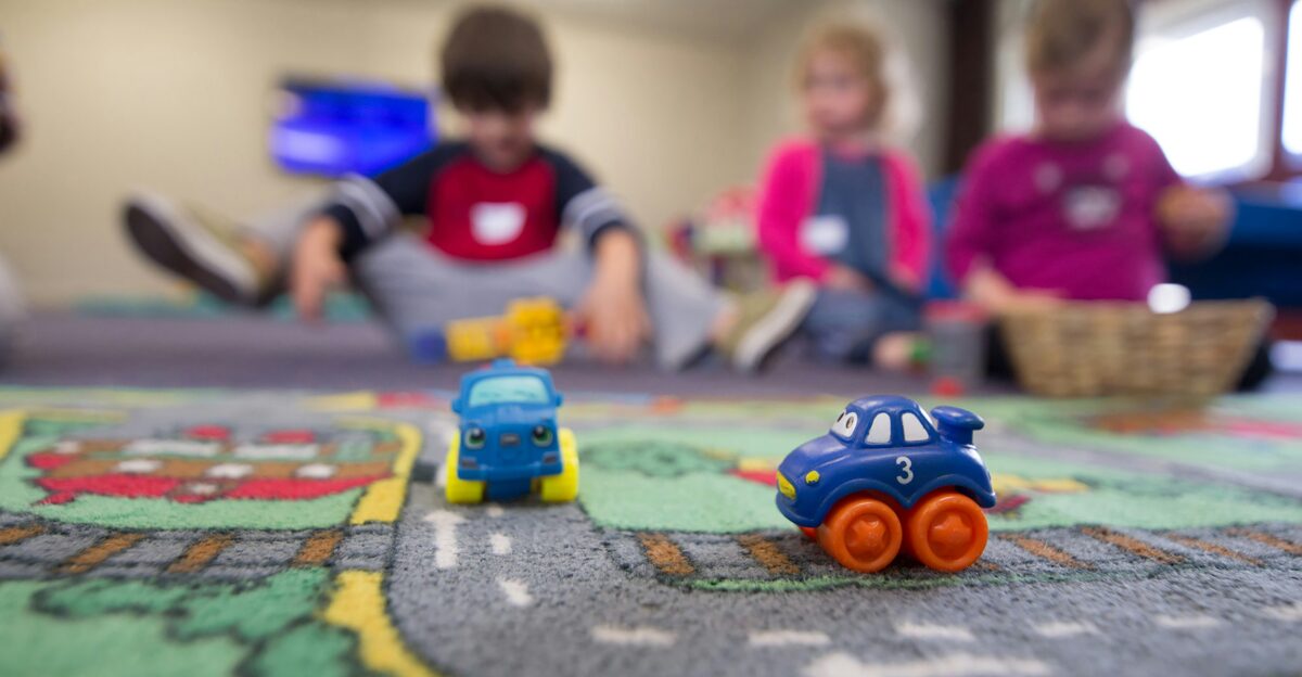 a group of children playing with toys on the floor