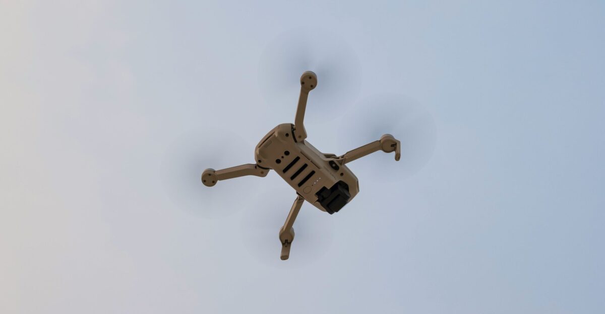 white and black drone in mid air