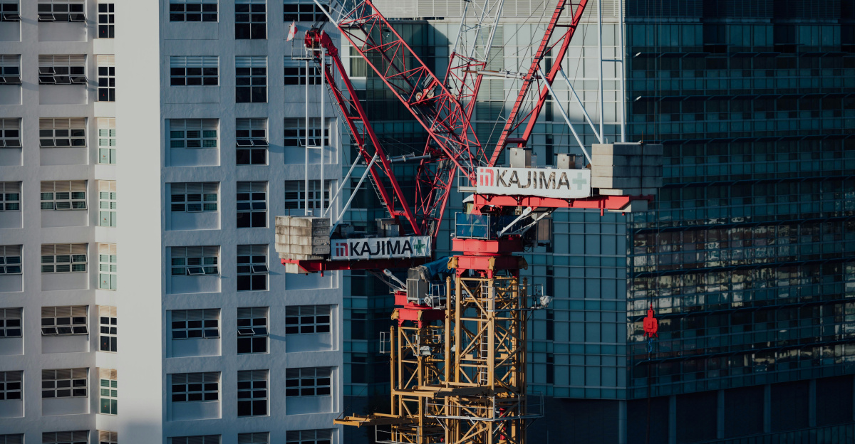 white and red crane near white concrete building during daytime