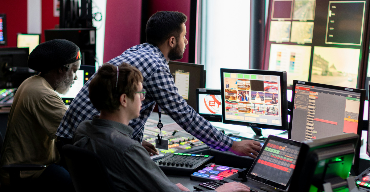 man in black and white checkered dress shirt sitting on black office rolling chair
