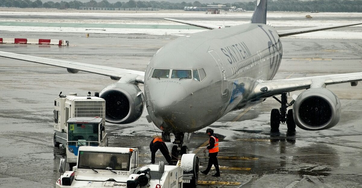 white and blue airplane on airport during daytime