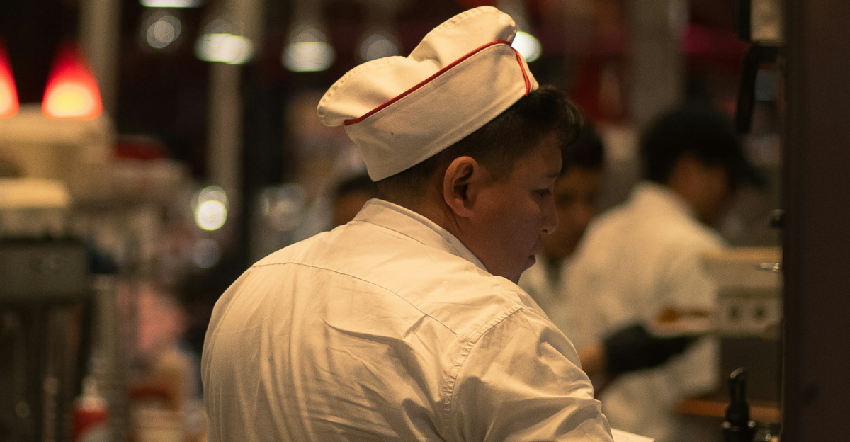 man in white long sleeve shirt and black pants wearing brown hat standing near store