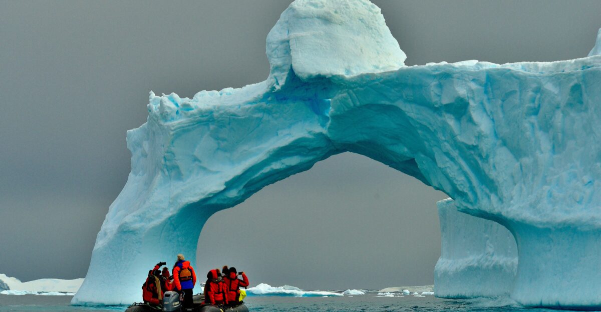 people sitting on ice formation during daytime