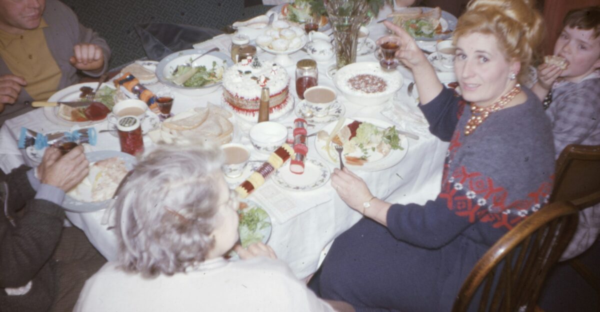 girl in white long sleeve shirt sitting on brown wooden chair