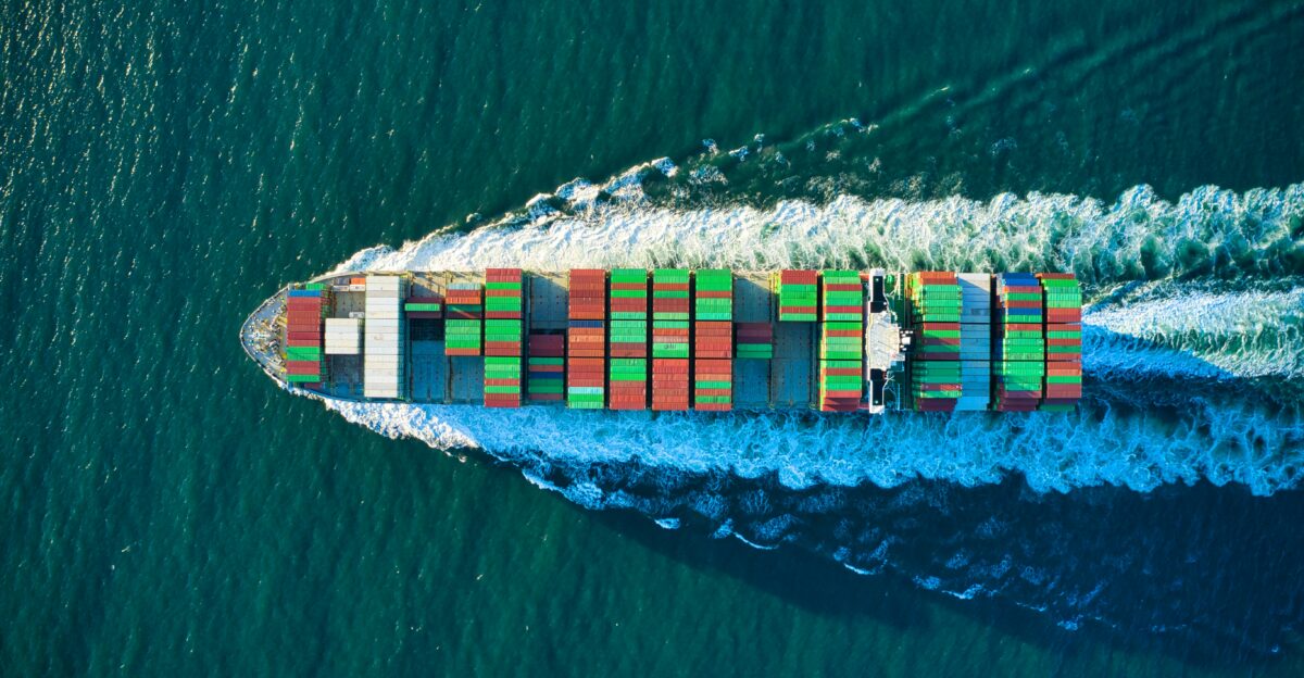 aerial view of blue and white boat on body of water during daytime