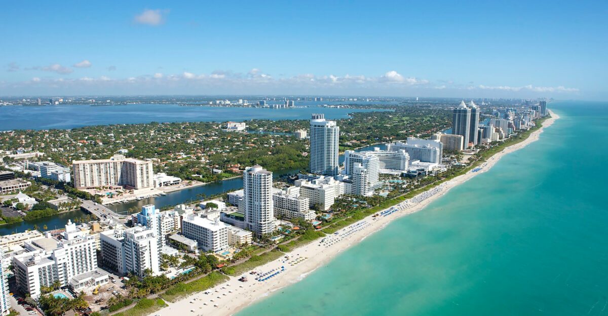 aerial view of city buildings near body of water during daytime