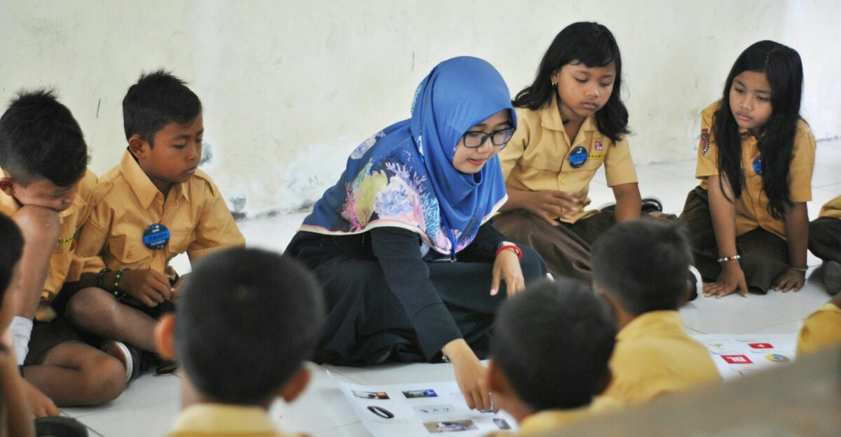 woman in blue hijab sitting on chair