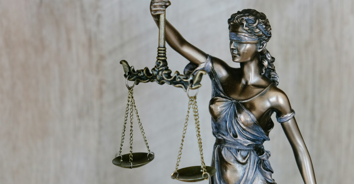 woman holding sword statue during daytime