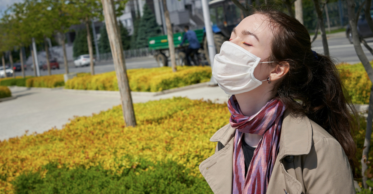 girl in pink jacket standing on gray concrete floor during daytime