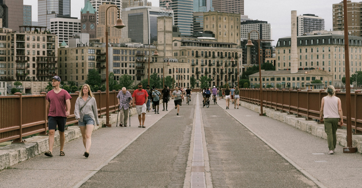 people walking on sidewalk near city buildings during daytime