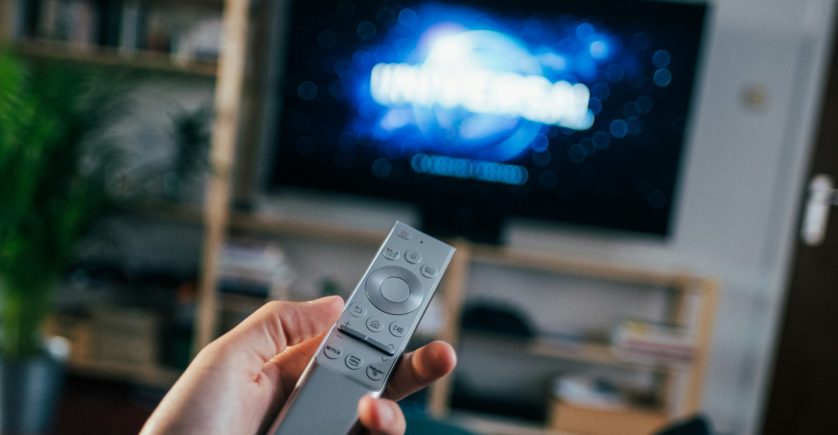 person holding gray remote control