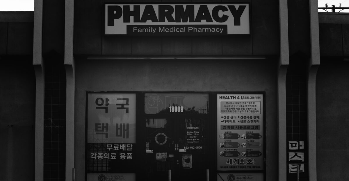 a black and white photo of a pharmacy