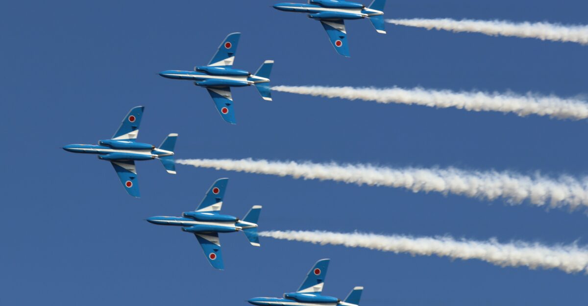 four blue and yellow jet planes