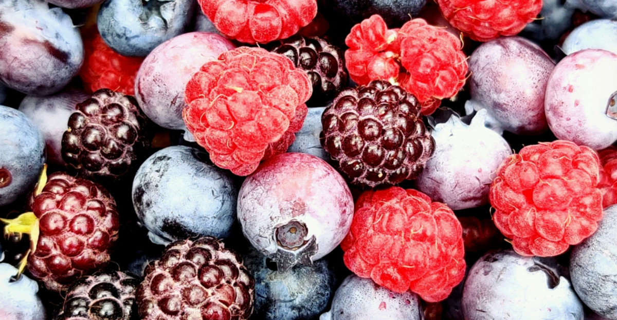 red and black berries on black surface