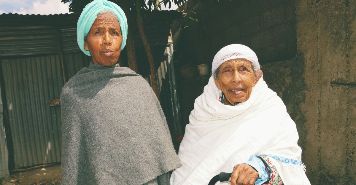 2 women in white hijab standing near green palm tree during daytime