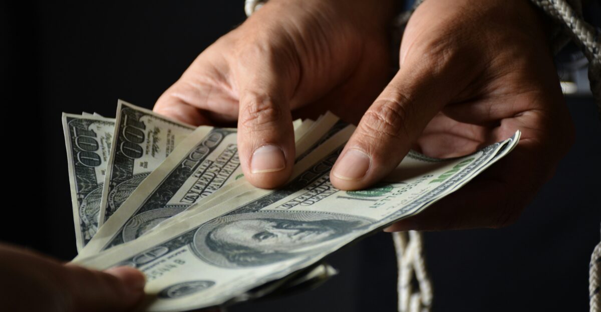 person holding 100 us dollar bill