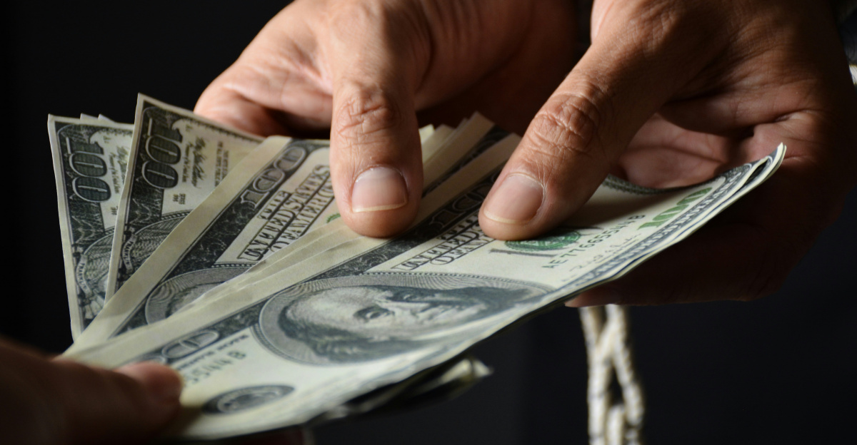 person holding 100 us dollar bill