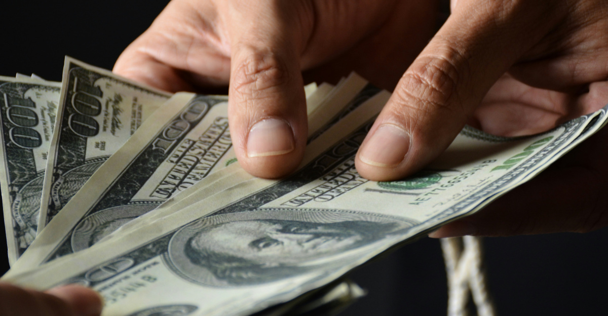 person holding 100 us dollar bill