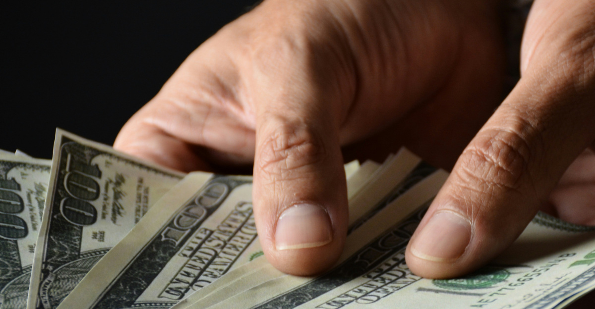 person holding 100 us dollar bill
