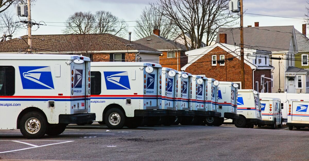 white and red van parked near bare trees during daytime