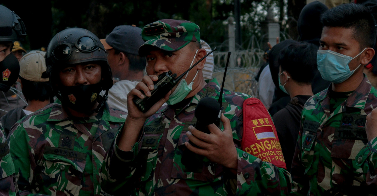 group of men in green camouflage uniform standing on green grass field during daytime