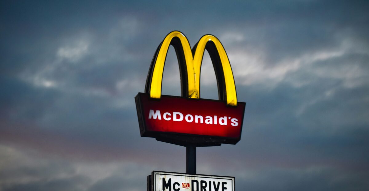 a mcdonald s sign with a cloudy sky in the background
