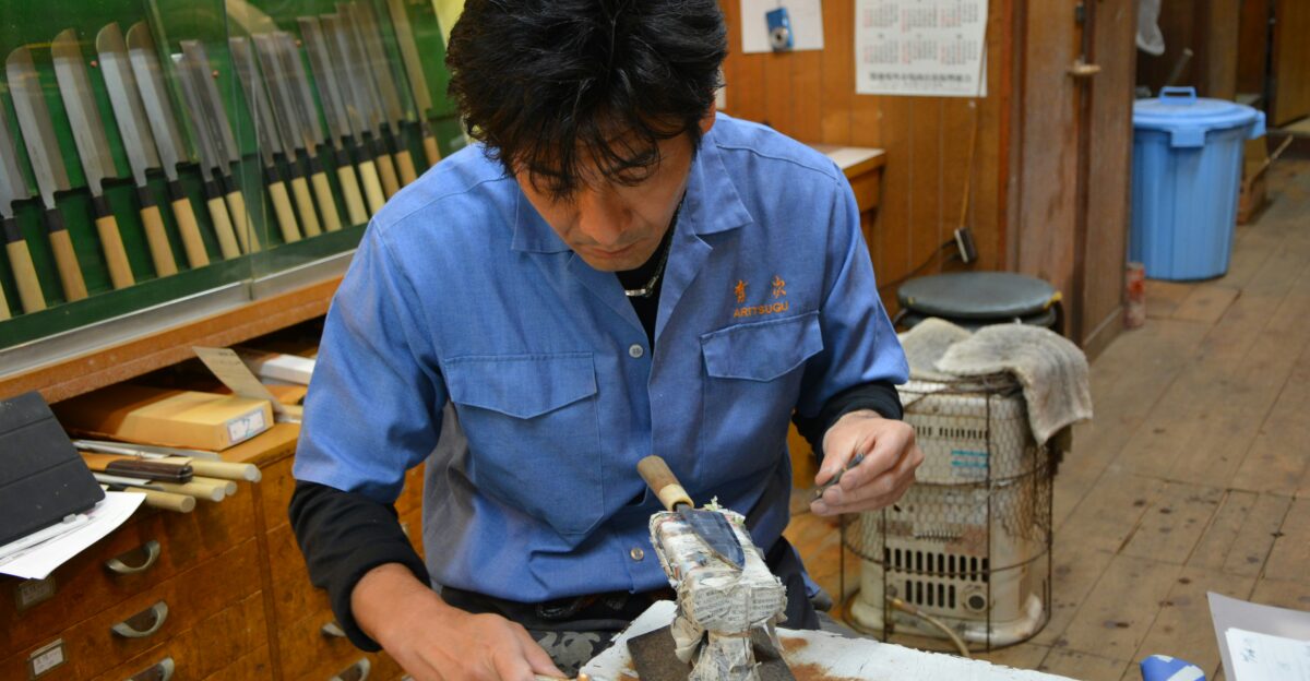 man in blue dress shirt holding white plastic pack