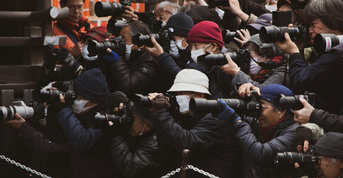 people in black jacket taking photo