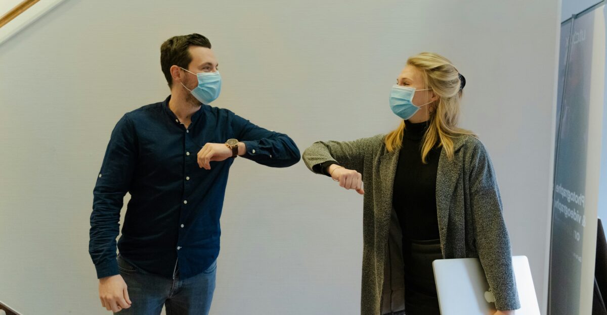 woman in black jacket holding white paper